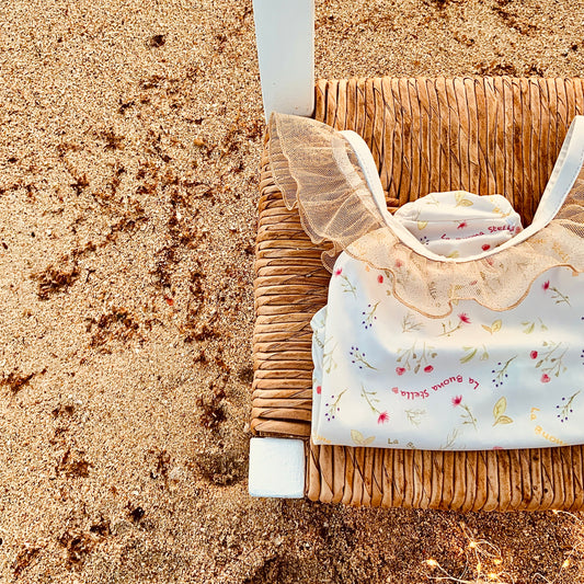 Costume mare bambina avorio con stampa floreale-logo e volant glitter